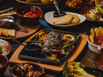 Delicious tapas assortment: grilled meats, vegetables, and various appetizers.