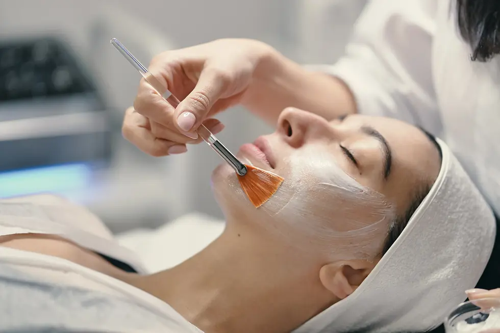 A therapist applying chemical peel to a patient's face