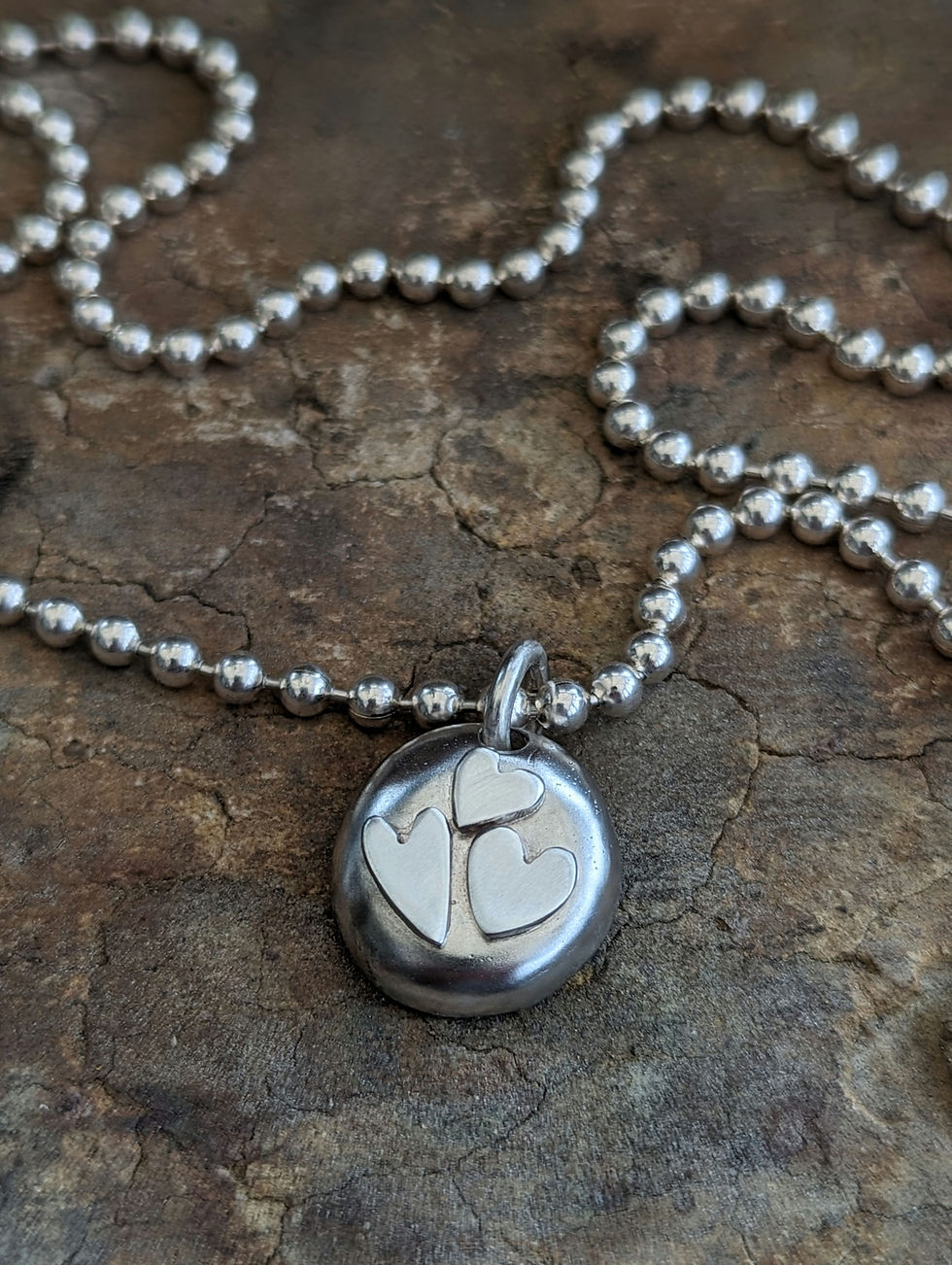 A very gorgeous Tripple Heart Pebble Pendant ( price excluding chain)