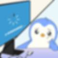 A worried cartoon penguin sits at a desk, staring at a computer screen displaying a loading symbol and the word "LOADING" in blue.