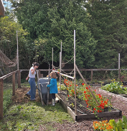 two people working in a garden with tools