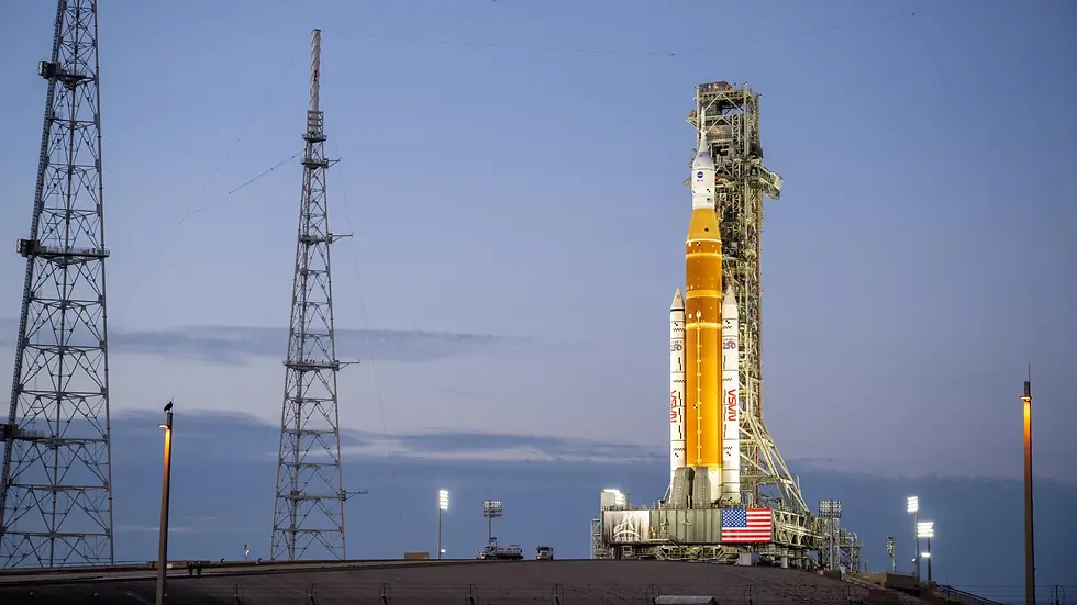 The Artemis II rocket stands poised on the launch pad at dawn, readying for its mission to propel humanity back to the moon.