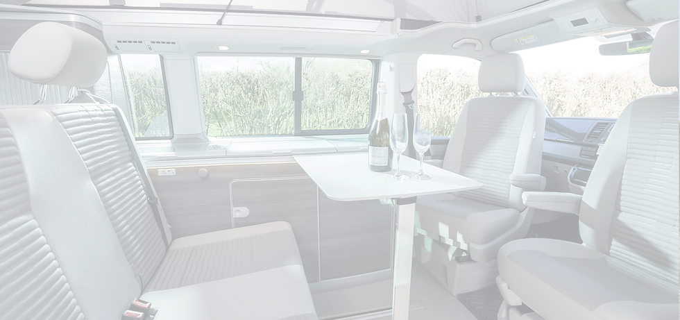 Interior of VW California Dining Area with Champagne & Glasses on Table