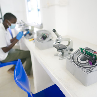 Man sitting in a white water testing lab with water point sensors and microscopes