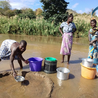 Women washing at the river and collecting pails of water