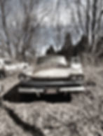 A broken-down car in black and white