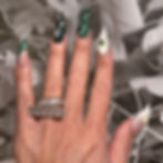 Nina Unrated's Stiletto nails with green and white holiday nail art