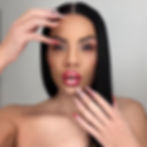 Nina Unrated with long black hair showcasing red and white nail art