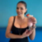 Nina Unrated holding a tropical drink for mobile content creation