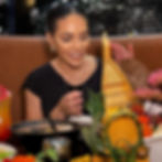 Nina Unrated smiling at sushi boat platter in restaurant