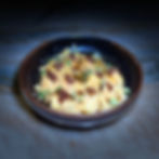 Gourmet dumplings with chili crisp and scallions.