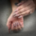 Nina Unrated's Long coffin nails with chrome swirls and pearl accents.