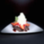 Chocolate brownie with whipped cream and strawberries