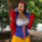 Nina Unrated in Snow White costume holding a red apple outdoors
