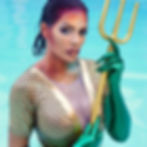 Nina Unrated in mermaid aquaman makeup holding a golden trident by a pool.