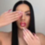 Nina Unrated with long black hair and heart patterned manicure