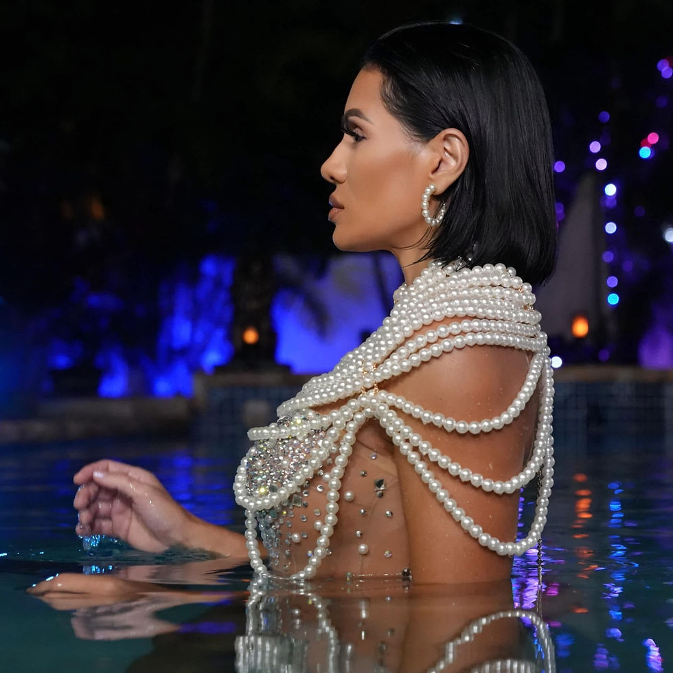 Nina Unrated wearing a pearl body chain in a pool at night