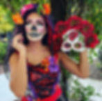 Nina Unrated with La Calavera Catrina skull makeup holding a mask.