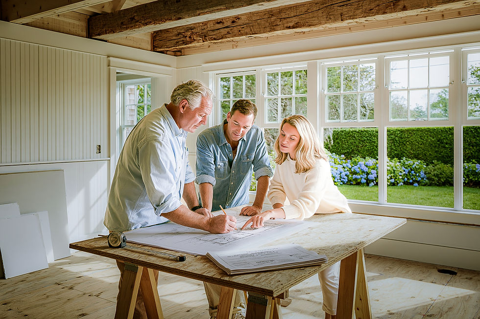Builder and homeowners reviewing plans inside a new addition, a key step with a home addition contractor on Martha's Vineyard