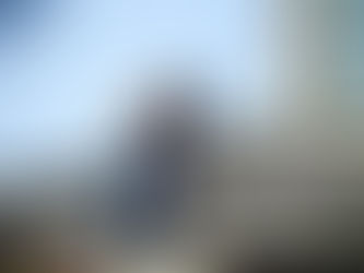 Worker removing damaged shingles during roof repair service on a residential home in Massachusetts