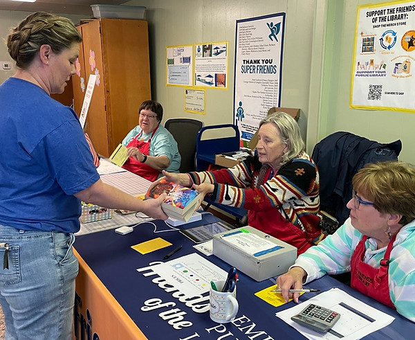 Woman buying book at sale