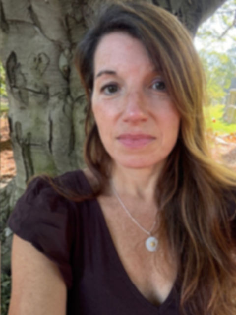 Gaze of Grace founder embracing spiritual growth beside ancient tree in Brooklyn NY