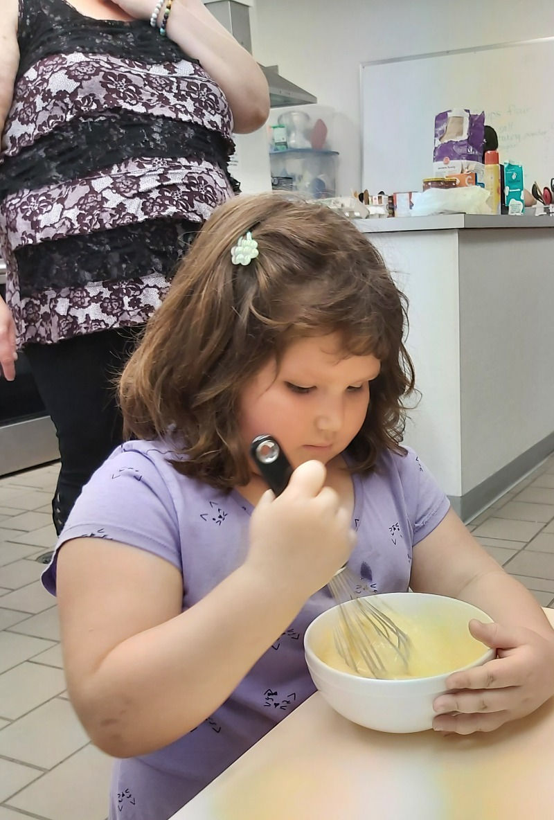 A child helping with meal preparation