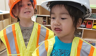 Two children in construction outfits