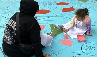 two children talking to an adult