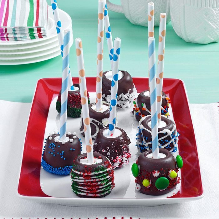 chocolate dipped marshmallow sticks decorated with colored sugar sprinkles and decorative party straws as party favors