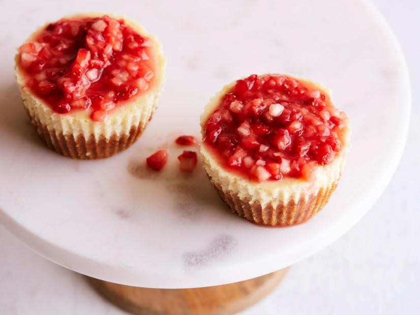 Individual sized cheesecake topped with strawberry compote