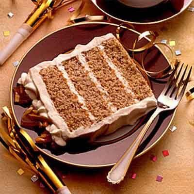 four layer eggnog flavored cake blended with almond praline crunch and frosted with meringue buttercream