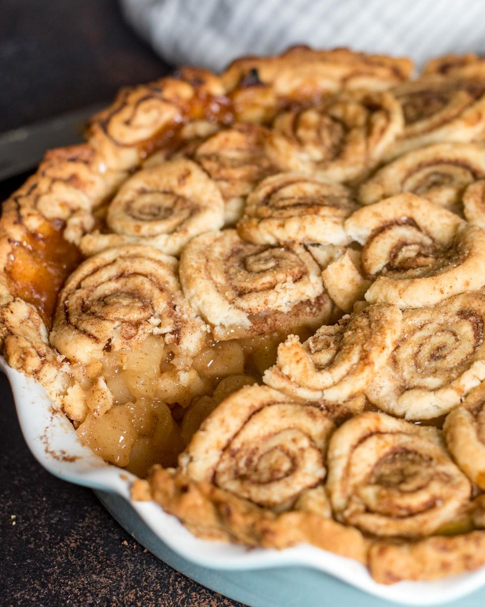 cinnamon roll apple pie served in fluted pie dish