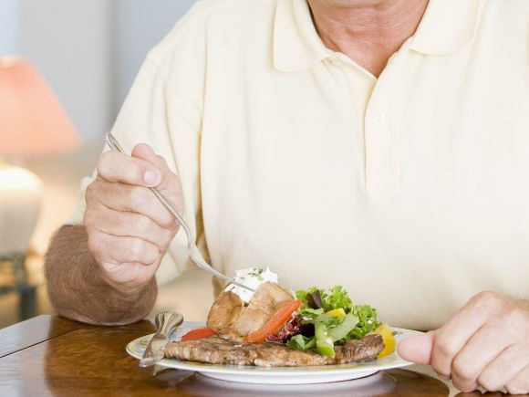 A man eating a plate of healthy food.