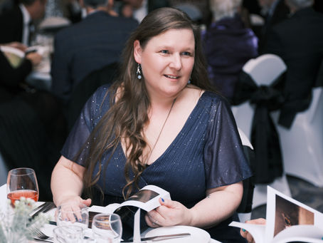 Claire dining at an event.