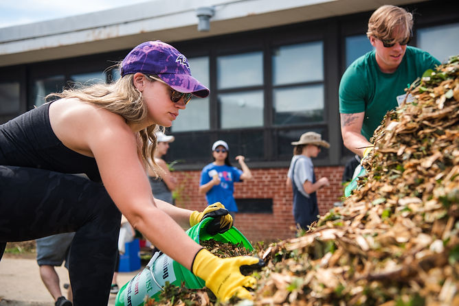Woman putting mulch in to a bucket
