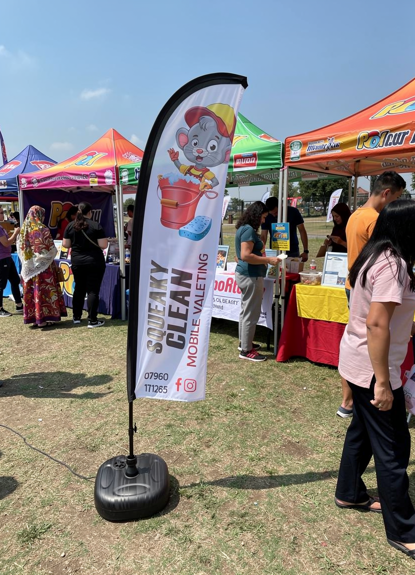 Tall vibrant feather flags for outdoor branding events.