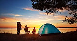 Campsite with family and tent at sunset