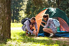 Two people setting up a tent for camping