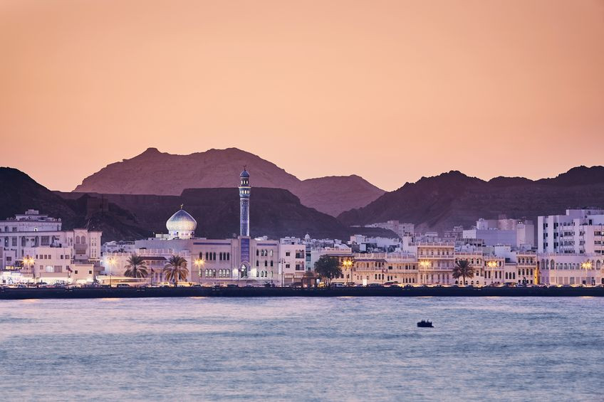 Cityscape view of Muscat city at golden sunset - the capital of Oman.