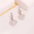 Ατσάλινα σκουλαρίκια με καρδιές κοντά 2.8cm ασημί