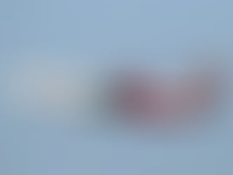 Red and white aircraft labeled "Air India Express" fly against a clear blue sky. The tail features a vibrant red design.