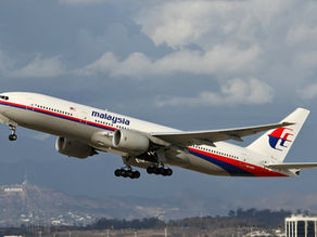 Airplane taking off, marked with "Malaysia Airlines," against a cloudy sky. "Hollywood" sign visible on hills in the background.