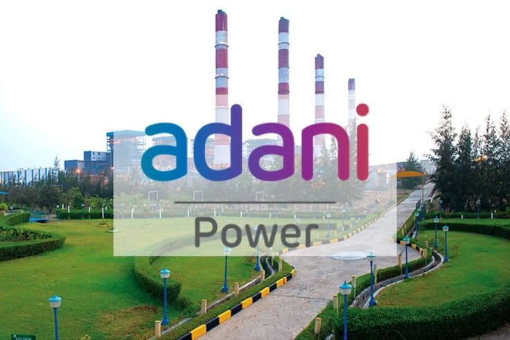Adani Power logo over a landscaped garden with pathways, green shrubs, and tall smokestacks in the background, creating an industrial yet serene scene.