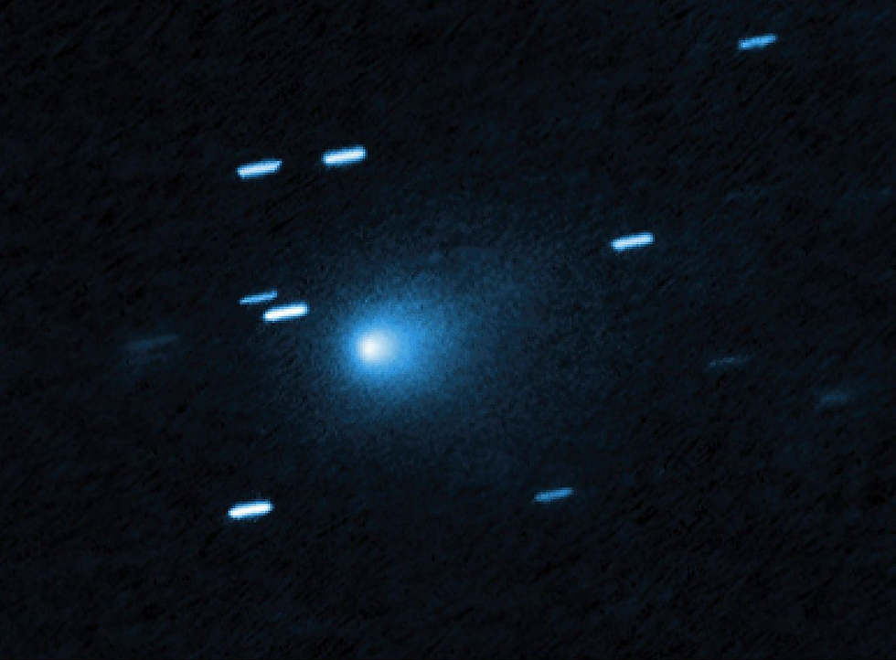 A glowing blue comet streaks through a dark space background, surrounded by blurred, elongated stars in motion.