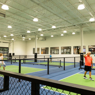 Indoor pickleball courts with commercial interior painting by EBR Construction