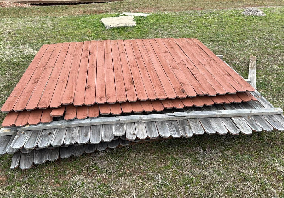Old fence panels next to new panels during a fencing replacement from EBR Construction.