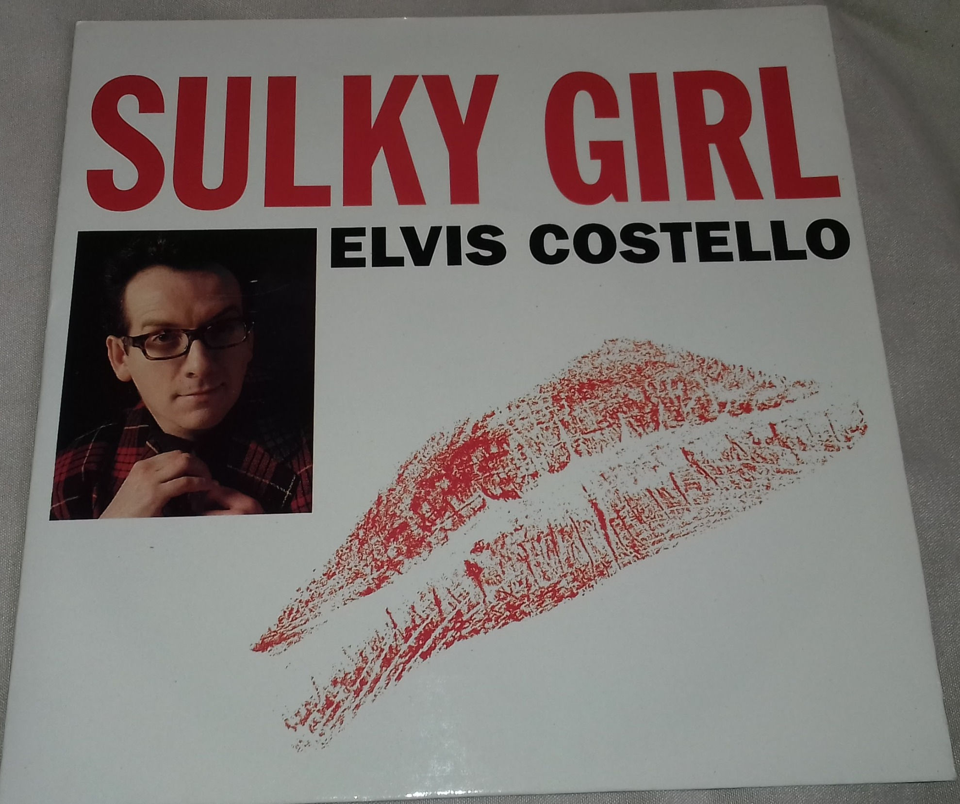 Elvis Costello - Sulky Girl (7", Single) (Warner Bros. Records, Warner Bros. Re