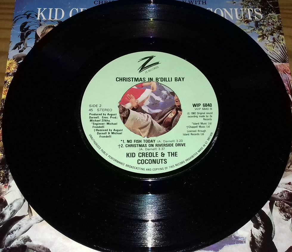 Miniatyrbild: Kid Creole & The Coconuts* - Christmas In B'Dilli Bay (7", EP) (ZE Records, Isl