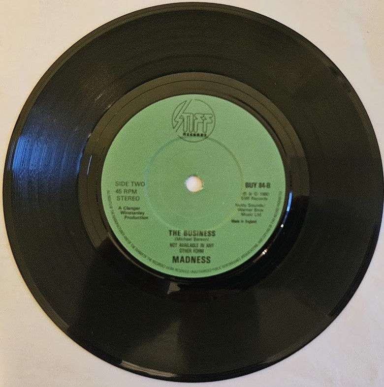 Miniature : Madness - Baggy Trousers (7", Single, Gre) (Stiff Records)